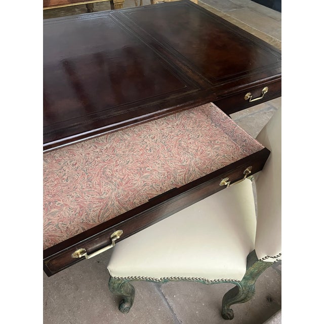 Maitland-Smith partners desk wrapped entirely in leather. The six drawers are lined with marbled paper and have brass...