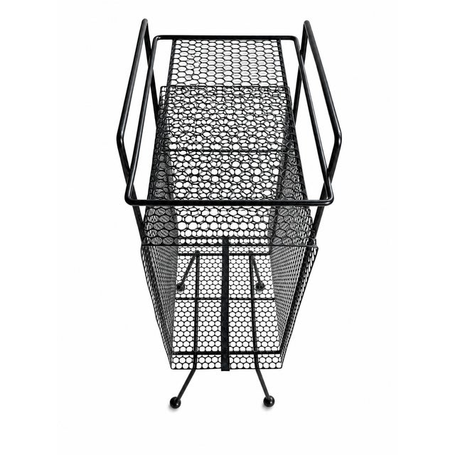 A distinctive 1950s Mid-Century Modern magazine rack and stand attributed to designer Richard Galef for Ravenware model...