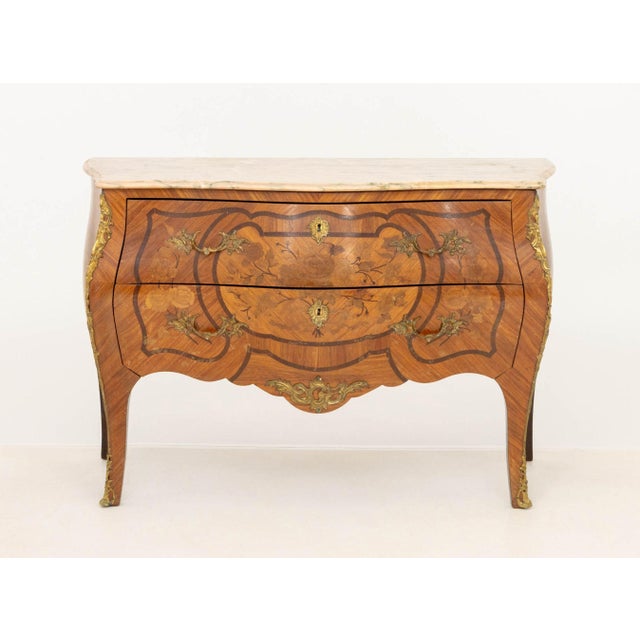 Louis XV Style Walnut Bombe Commode, pink marble top above two drawers with marquetry inlay on scroll form legs. 31.25" H...