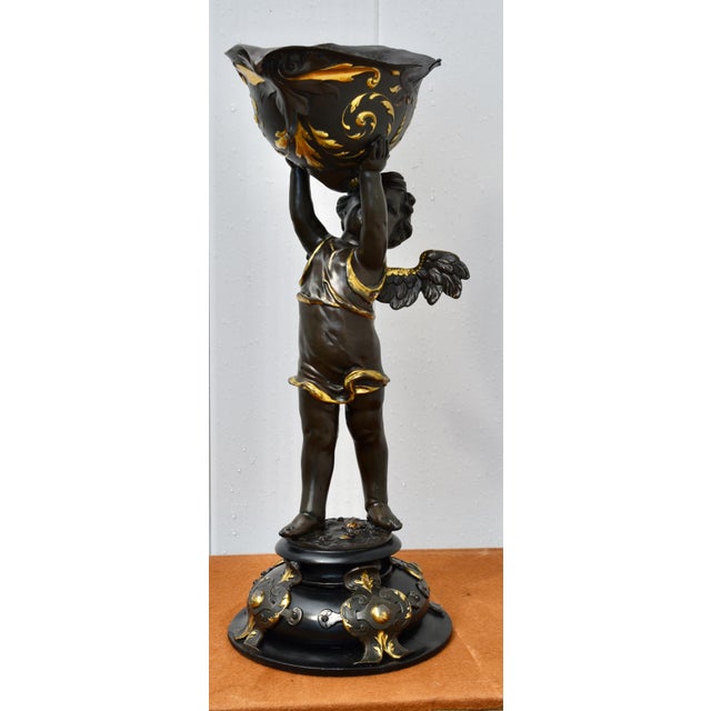 Antique - late 19th Century Statue - Cherub Holding a Shell has a French Rococo Style. Bronze Statue with a Bronze Finish...
