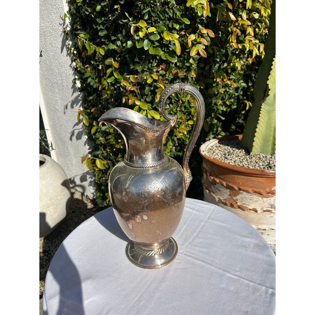 Large vintage Rogers Bros. Meriden silver plate pitcher featuring a classic urn-form body, pedestal base, and elegantly...