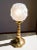 Art Deco table lamp from the 1930s, featuring a frosted glass shade decorated with a floral motif. The octagonal solid...