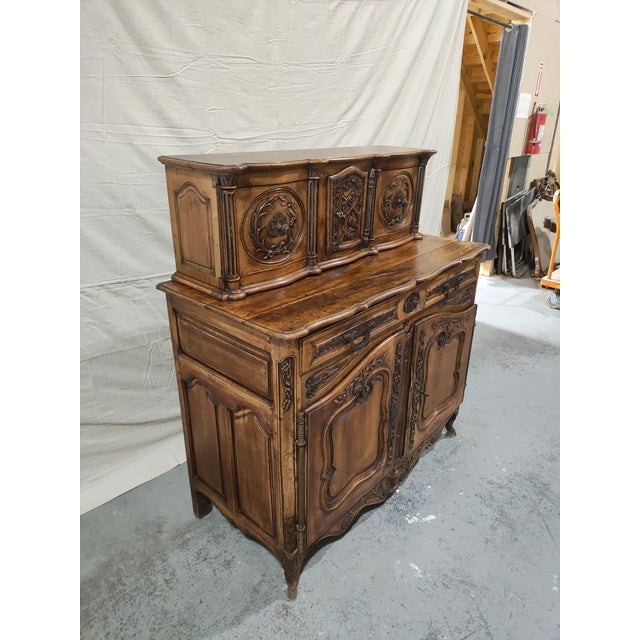An exceptional and highly sculptural mid-19th century French Provincial buffet à deux corps, dating to circa 1850 and...