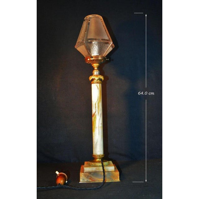 An exceptionally decorative and substantial early 20th-century column table lamp, combining richly veined marble, cast...