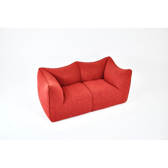 Red fabric sofa, model: Le Bambole by Mario Bellini. Seat height: 42 cm. Stamped B&B Italia. Wear consistent with age and...