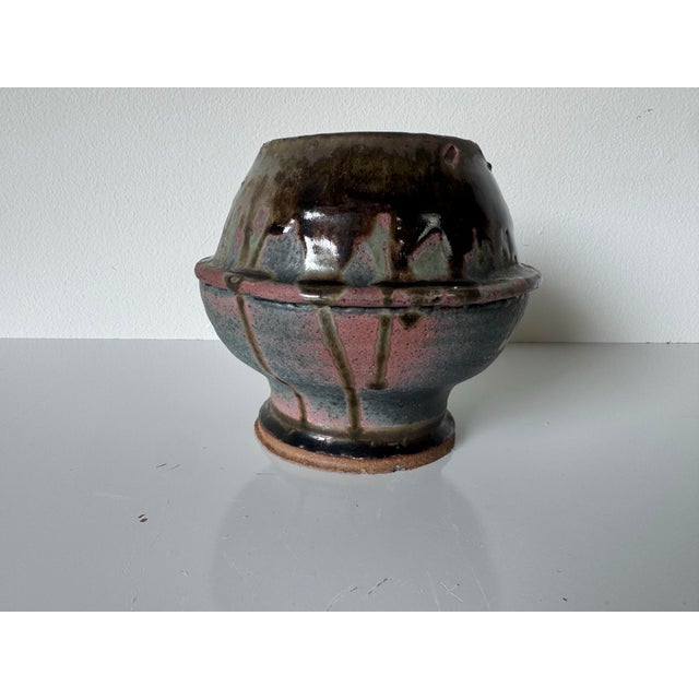 A distinctive 1980’s vintage handmade studio pottery vase, showcasing the artistry and individuality of small-batch...