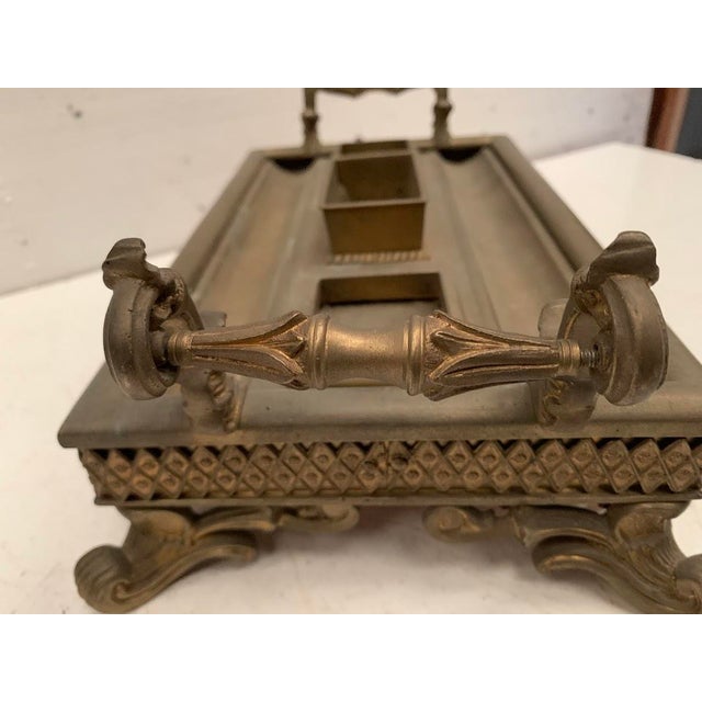 Bronze inkwell in the napoleon iii style it rests on four scrolled feet two-handled grip good condition dimensions: h 13 x...