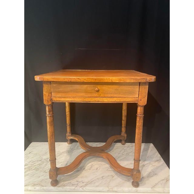 Elegant French walnut side or occasional table featuring a richly embossed leather top with a warm, time-softened patina....