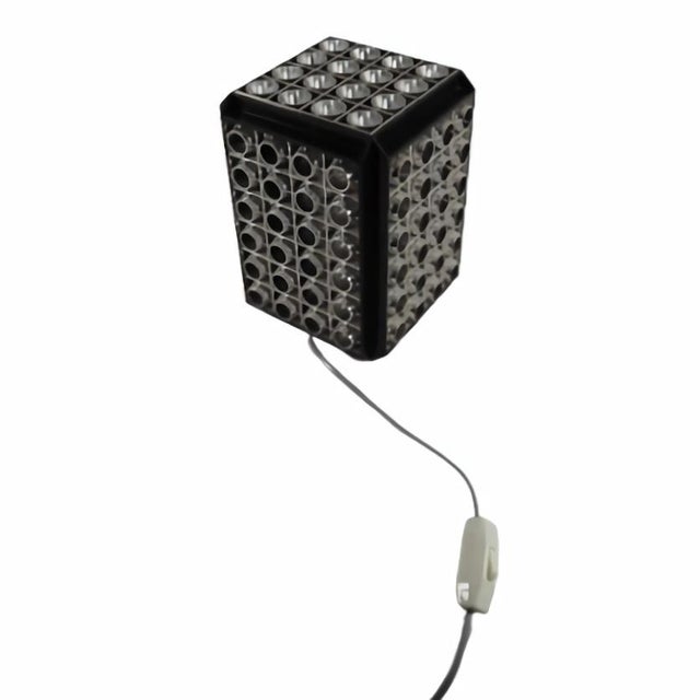 A striking and atmospheric space age table lamp produced by p. W. Denmark in the 1970s, model “rotina colour”, combining...