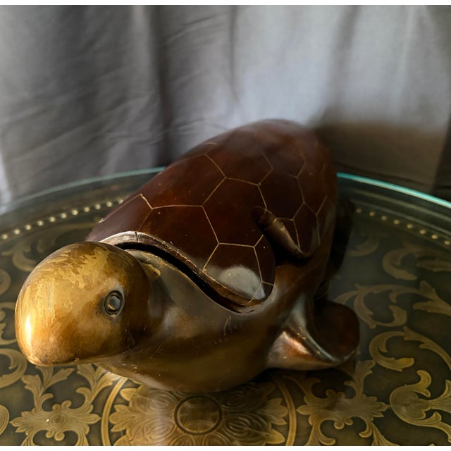 This majestic hand-carved ironwood sea turtle sculptural box features a removable shell lid, designed without hinges and...