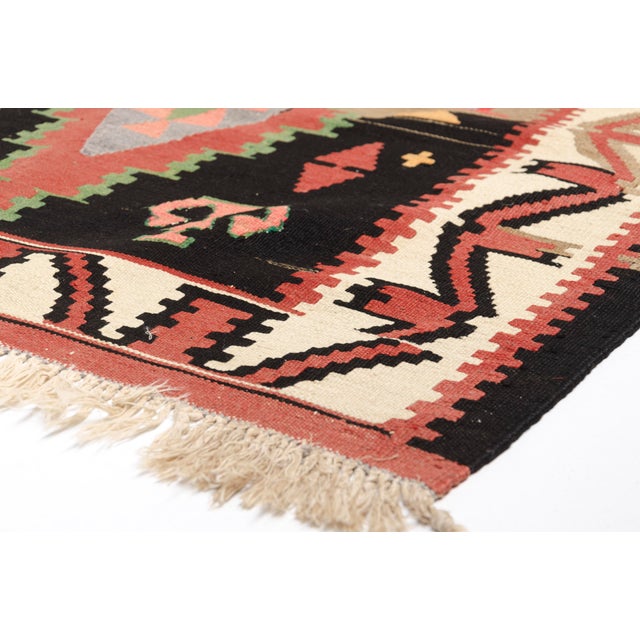 This is a vintage Turkish Oushak rug from the Mid 20th Century. The piece was hand-knotted.