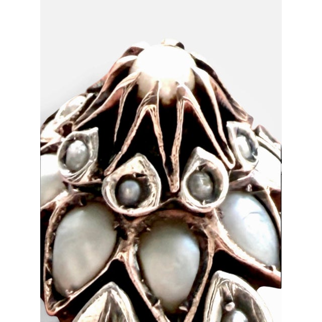 A beautifully composed antique dome ring crafted in 9K gold and 800 silver, featuring an intricate floral arrangement of...