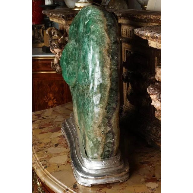Impressive large-scale green fluorite sculpture mounted on silver leaf base.