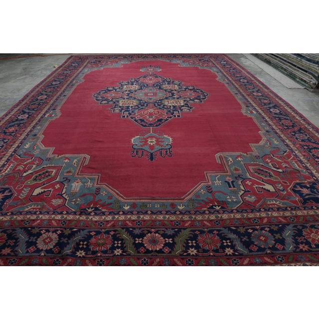 Made with hand-knotted wool and originating in the early 20th century, this 15x22 antique Persian rug is a rare and...