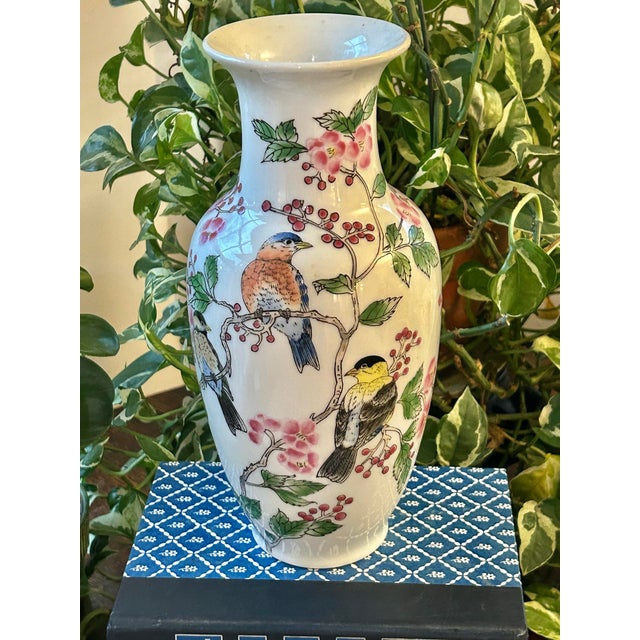 This porcelain chinoiserie vase is hand painted and made for export in the late 20th century. It stands 10” tall and...