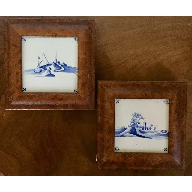 Pair antique 18th century Dutch Delft blue and white tin glaze faience tiles in burl walnut frames. Each measures 8"...