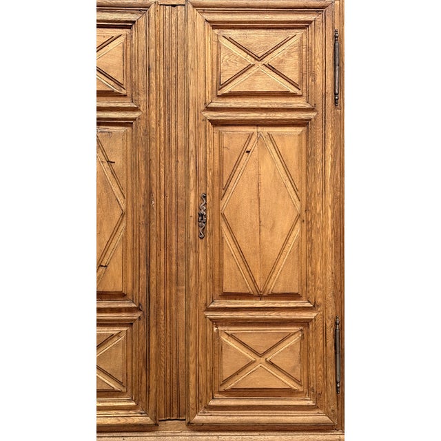 Solid oak wardrobe from 1700, with paneled sides and doors embellished with a refined diamond-shaped workmanship. Solid...