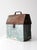 Mid-century galvanized metal toolbox with an old green-painted finish, pitched hinged lid, metal carrying handle, and...