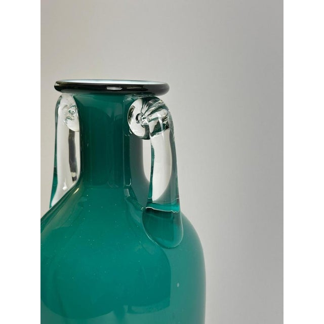 This turquoise cased glass amphora vase by Jerzy Słuczan-Orkusz for Tarnowiec Glassworks was produced in Poland in the...