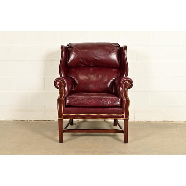 A gorgeous Chippendale style wingback library chair, lounge chair, or fireside chair By Hancock & Moore USA, Circa 1980s...