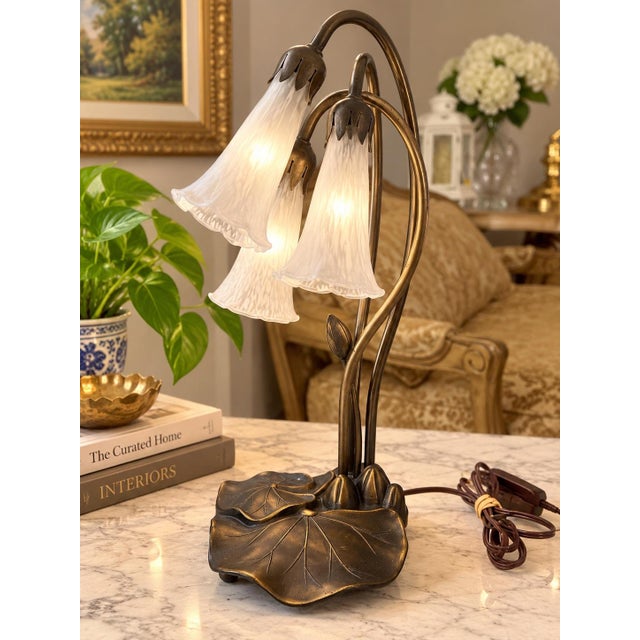 Striking vintage three-light table lamp featuring an elegant sculptural design inspired by lotus flowers and botanical...