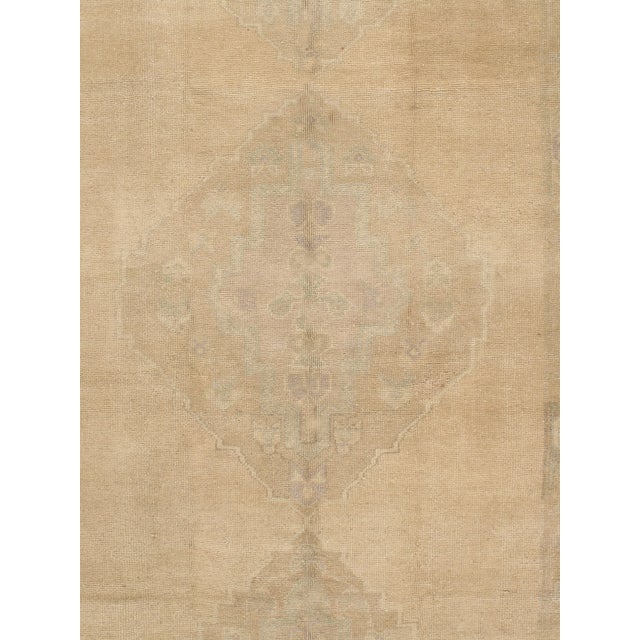 Vintage Turkish rug in a warm color palette, hand-knotted of high-quality wool. The intricate design and rich hues bring...