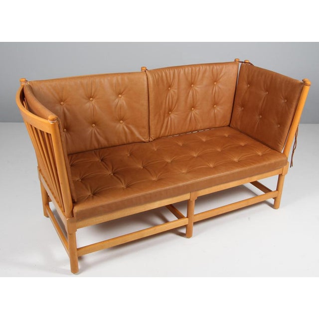 Børge Mogensen two-seat sofa in lacquered beech and new upholstered cushions of vintage cognac full grain aniline leather....