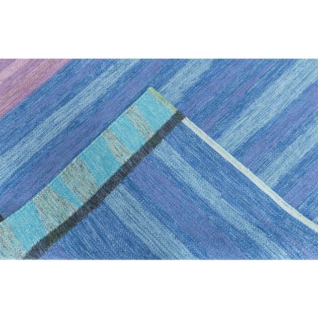 This vintage Swedish flat-weave rug from the 1960s is a striking example of mid-century Scandinavian design, where...