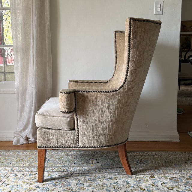 Vintage upholstered wingback lounge chairs by Drexel. Features a gracefully shaped wingback silhouette with hand-applied...