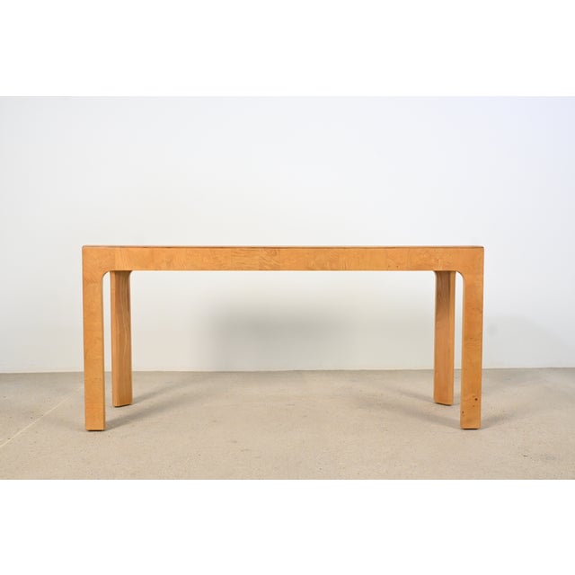 This Milo Baughman styled Henredon console table features a clean, modern silhouette with softly rounded legs and a...