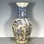 A striking Chinese blue and white porcelain vase featuring a heavy, all-over crackle glaze. The vase has a baluster shape...