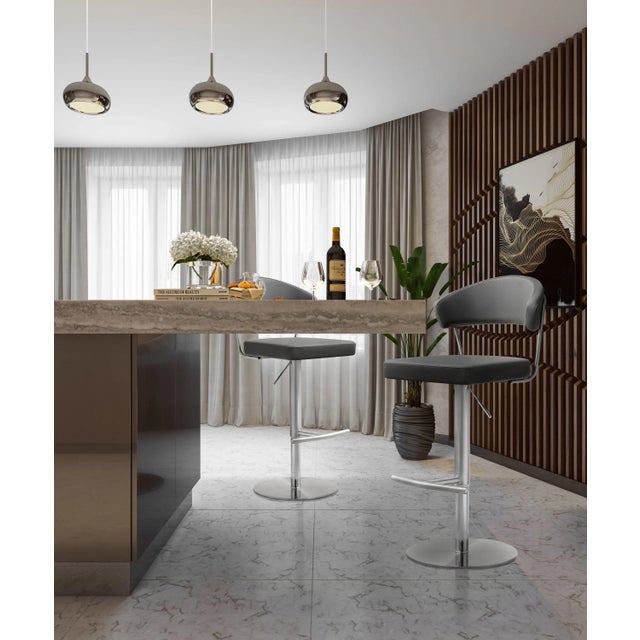 Furnish your kitchen or bar area in contemporary style with the Cosmo stool from TOV. The solid stainless steel frame...