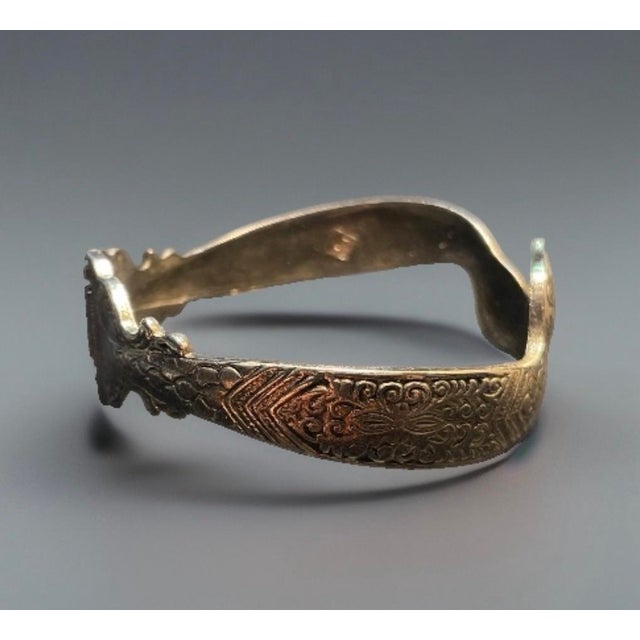 Vintage seductive snake bangle by Swank, hinged cuff bracelet with a heavy spring construction, making it a durable and...