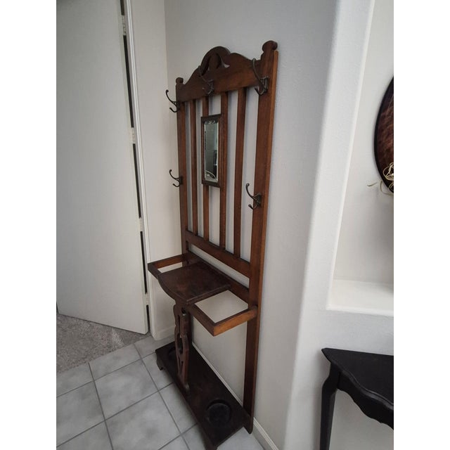 This is a quintessential arts and crafts style hall tree with a small mirror and made from oak. This piece is small and...