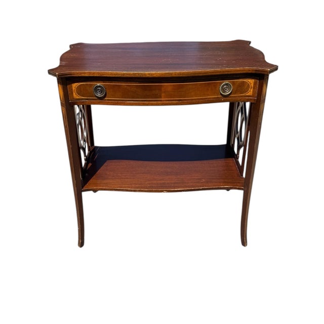 This is a delightful Edwardian mahogany and inlaid occasional table made in 1934. This has a useful drawer with two brass...