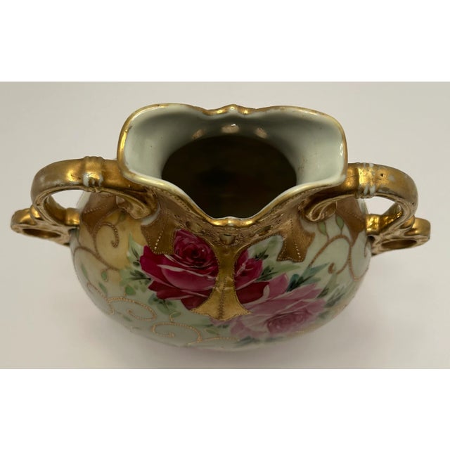This beautiful Nippon Vase has a beautiful rose motif on front and back with roses painted in dark and light pinks,...