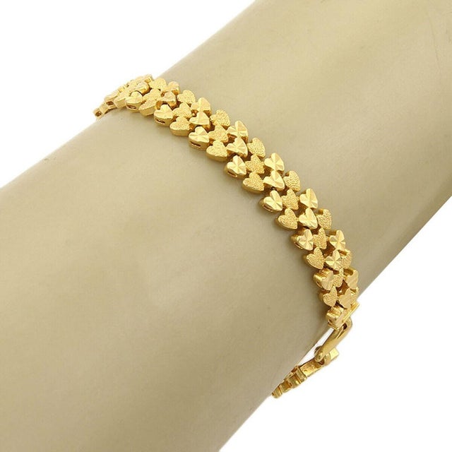 The product is a Textured 22k Gold Heart Link Bracelet, featuring a vintage design with an original style. This fine...