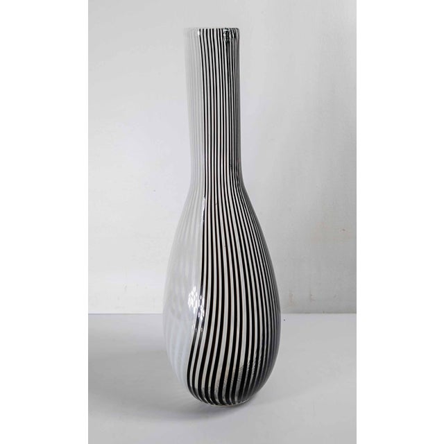 We are selling this pretty Mid-Century Modern art glass. This Italian Murano glass type bottle vase has black and white...