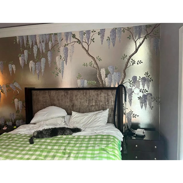 Exquisite hand-painted chinoiserie wall panel featuring cascading wisteria blossoms on shimmering silver leaf background....