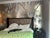 Exquisite hand-painted chinoiserie wall panel featuring cascading wisteria blossoms on shimmering silver leaf background....