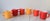 Set of six vibrantly colored, stackable milk glass mugs with an orange peel texture. Red, yellow and orange. No makers...