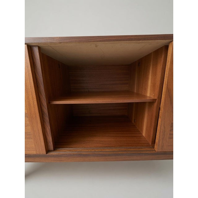 Beautiful Mid-Century Modern Danish rosewood and teak credenza by E. Jakobsen Skive, made in Denmark (unmarked). This...