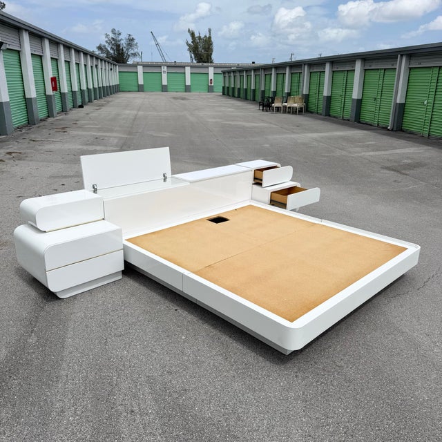 A bold and futuristic postmodern king-size platform bed, executed in a sleek white gloss laminate with signature waterfall...