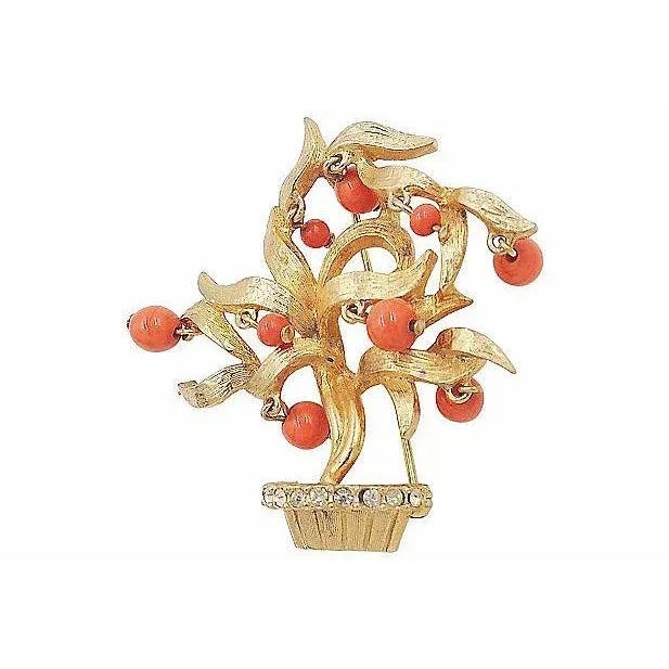 1960s goldtone faux-coral glass beads and clear rhinestones tree pin with security clasp. Marked "Pauline Rader."...