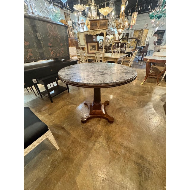This 19th c. Italian Walnut Center Table is a stunning piece . Featuring a pretty wood base and original marble. Lovely!...
