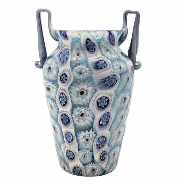 An intricate composition of millefiori murrine, this Murano vase shimmers with luminous blues and layered patterns....