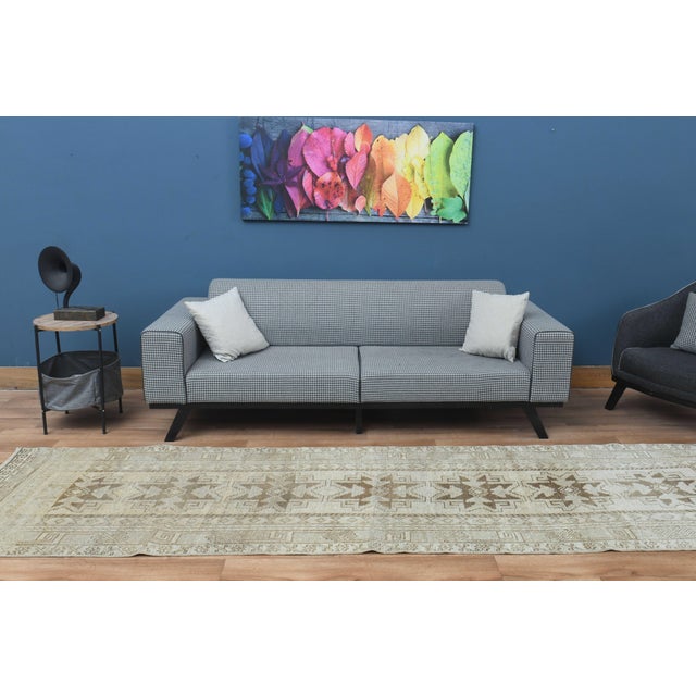 Vintage Hand-Knotted runner rug is a semi-antique vintage area rug. The '70s Eastern region of Anatolia's unique rug is...