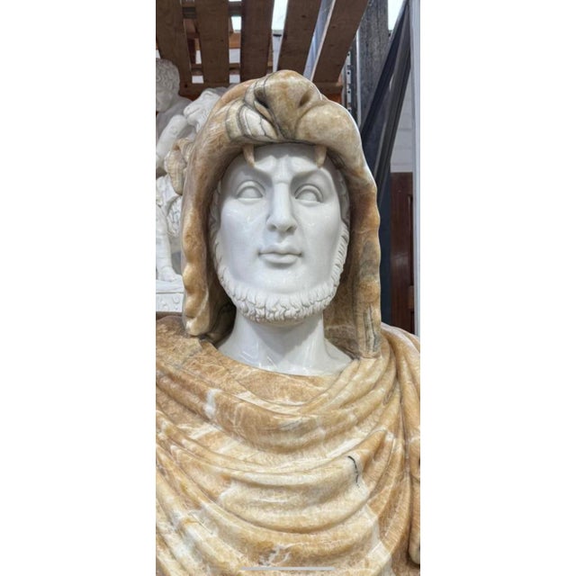 A powerful and majestic marble bust sculpture of Alexander the Great, embodying the charisma and strength of the legendary...