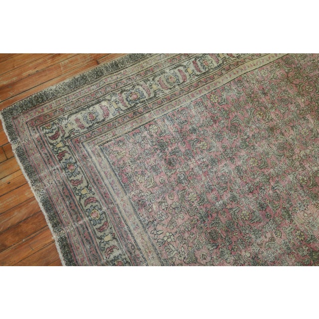 A 19th Century hand-knotted wool Persian Rug with an all-over design on a pink field. Professionally Cleaned and able to...