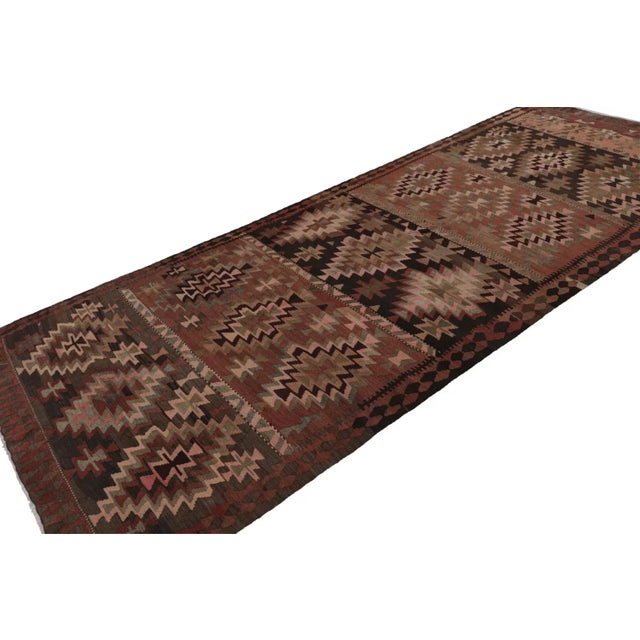 Handwoven in wool, circa 1950-1960, this 6x14 vintage Afghan tribal kilim and gallery runner rug features a minimal...